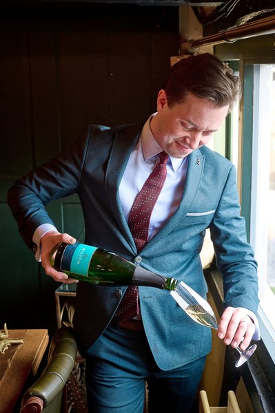 Proprietor Daniel Crump pouring a glass of Champagne